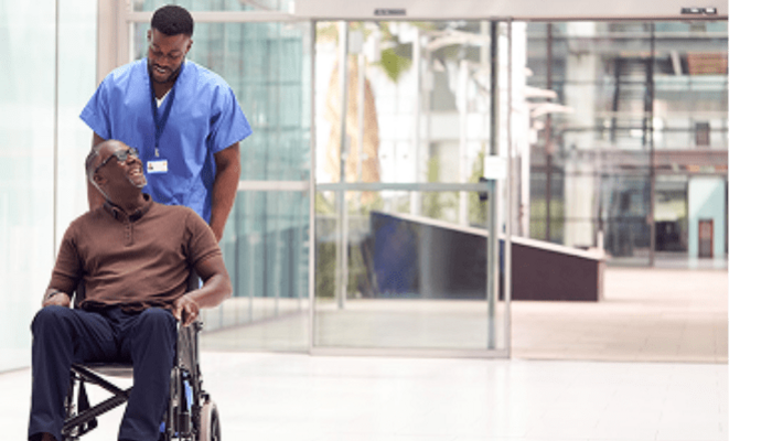 Male Nurse pushing wheelchair