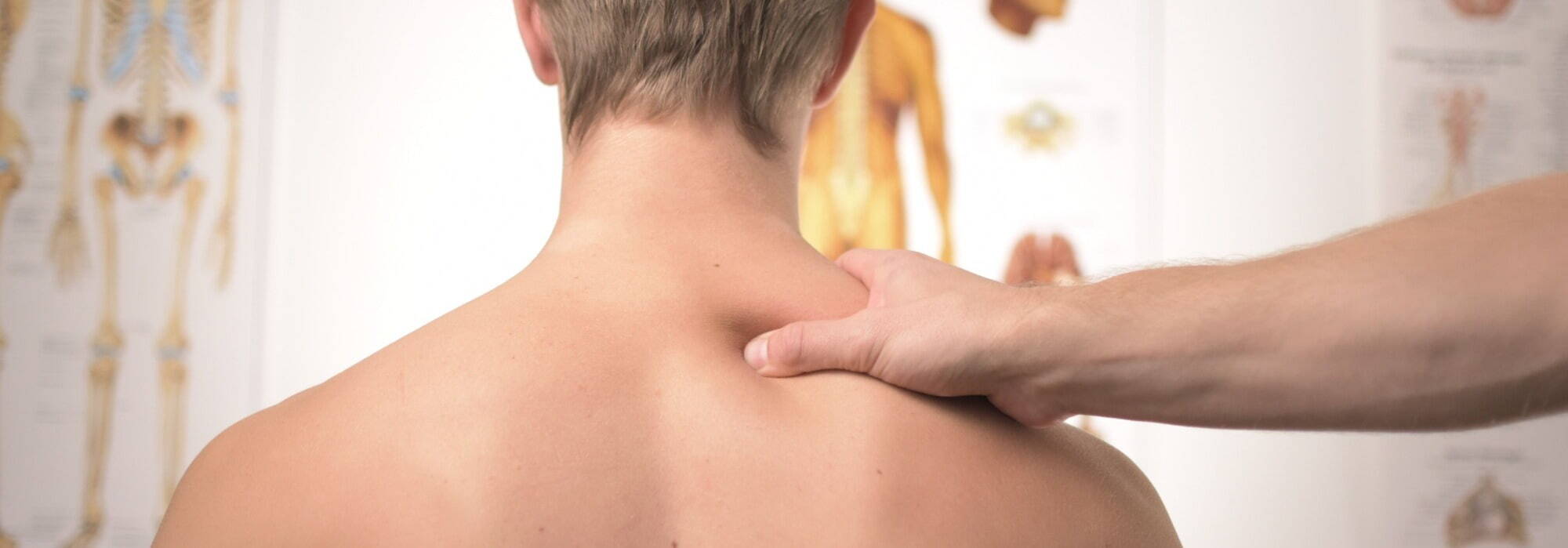 Physiotherapist providing shoulder massage to patient